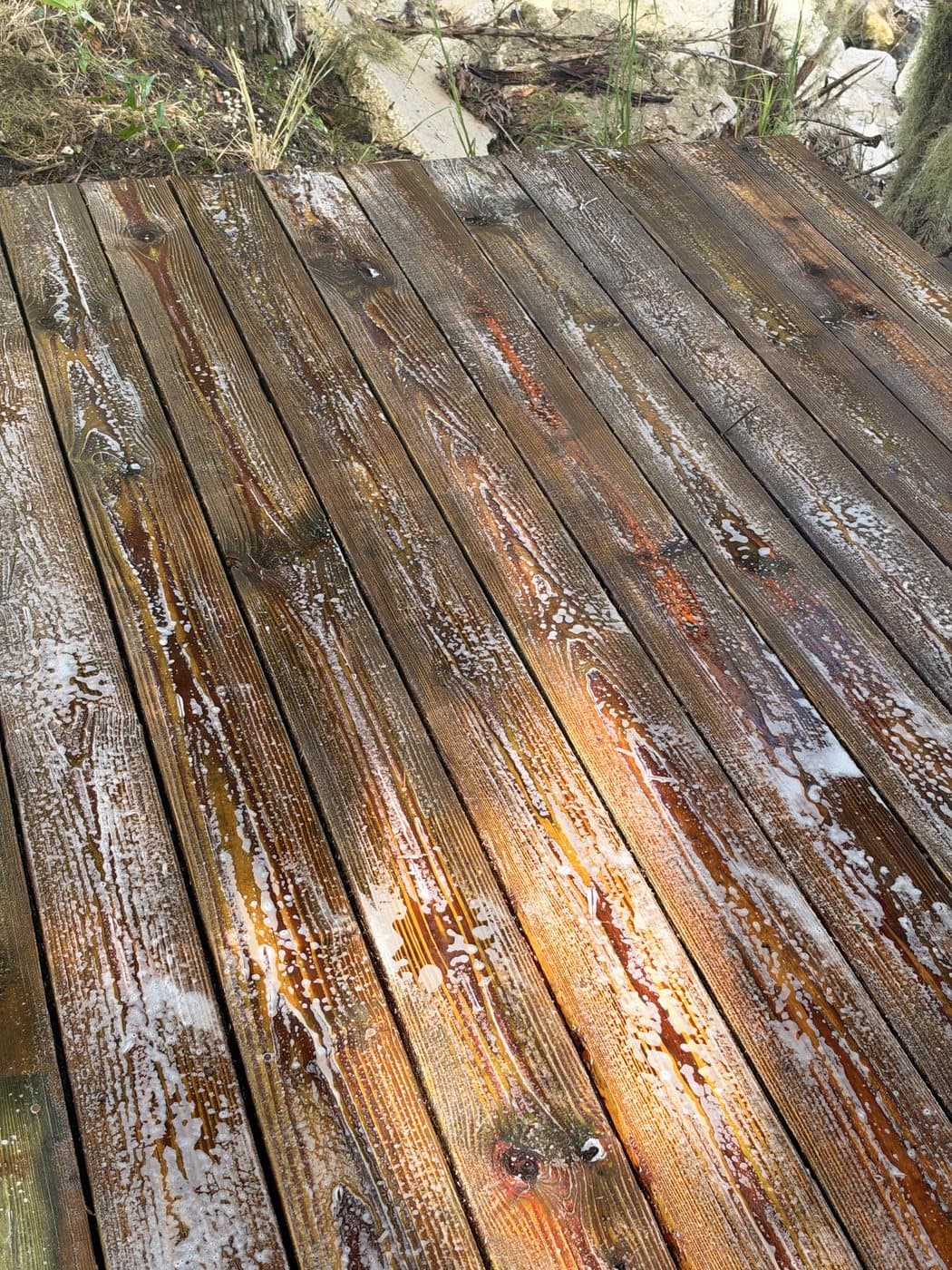 Wood dock boards mid-cleaning