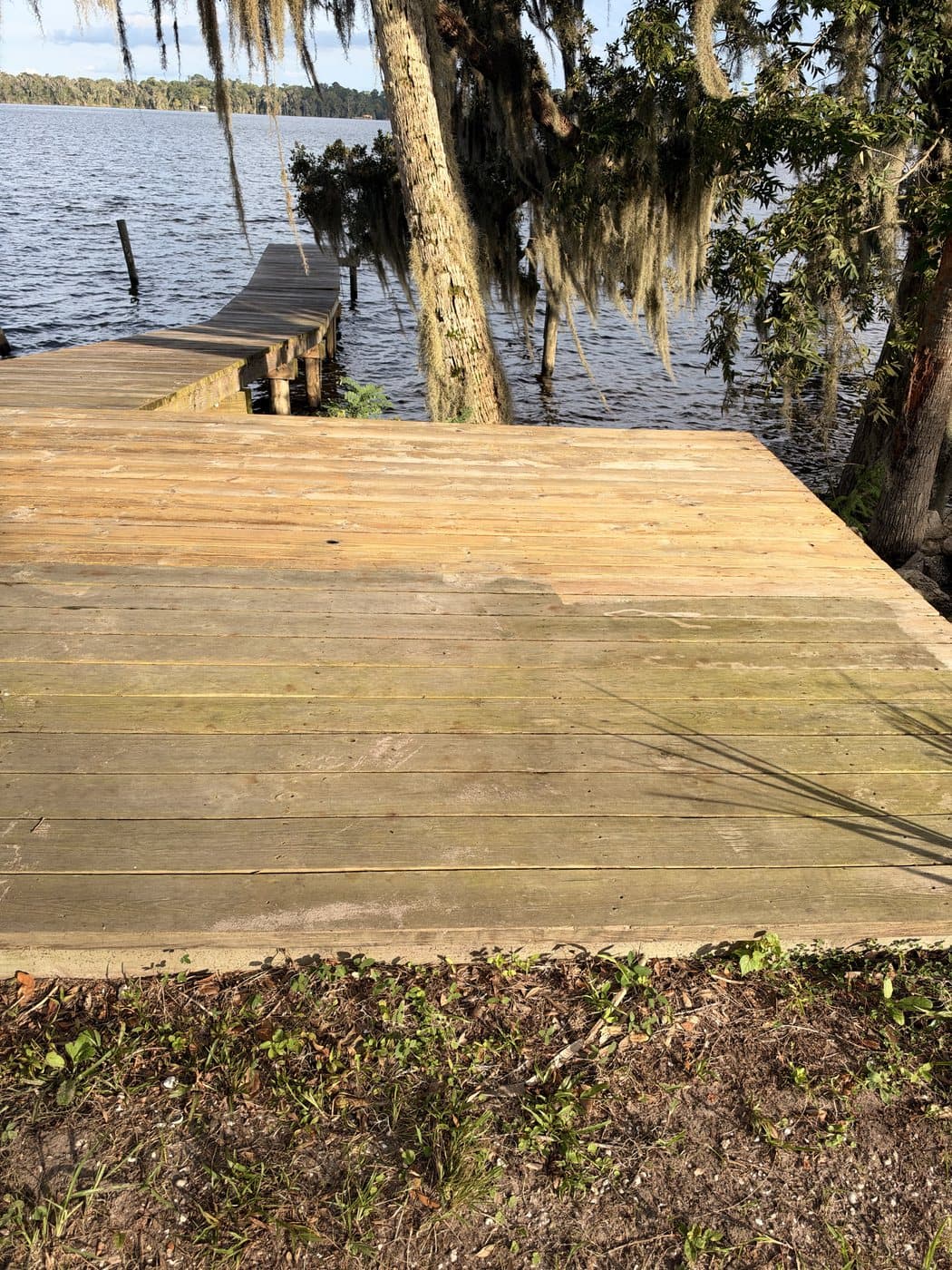 Waterfront wood deck partly cleaned
